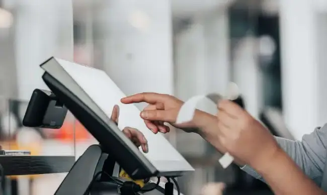 Person entering an order on a point-of-sale touchscreen terminal